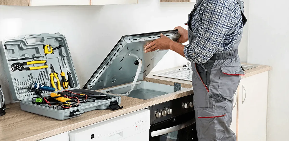 Handyman repairing a cooktop and checking wiring connections in Syracuse, NY