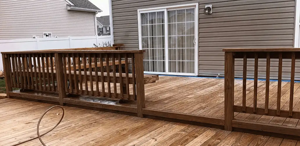 Deck sealing service protecting a backyard wood deck and railings in Syracuse, NY