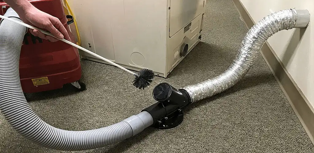 Dryer vent cleaning service removing lint from a dryer duct connection in Syracuse, NY