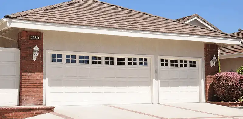 Residential garage door repair service for a double garage door in Syracuse, NY
