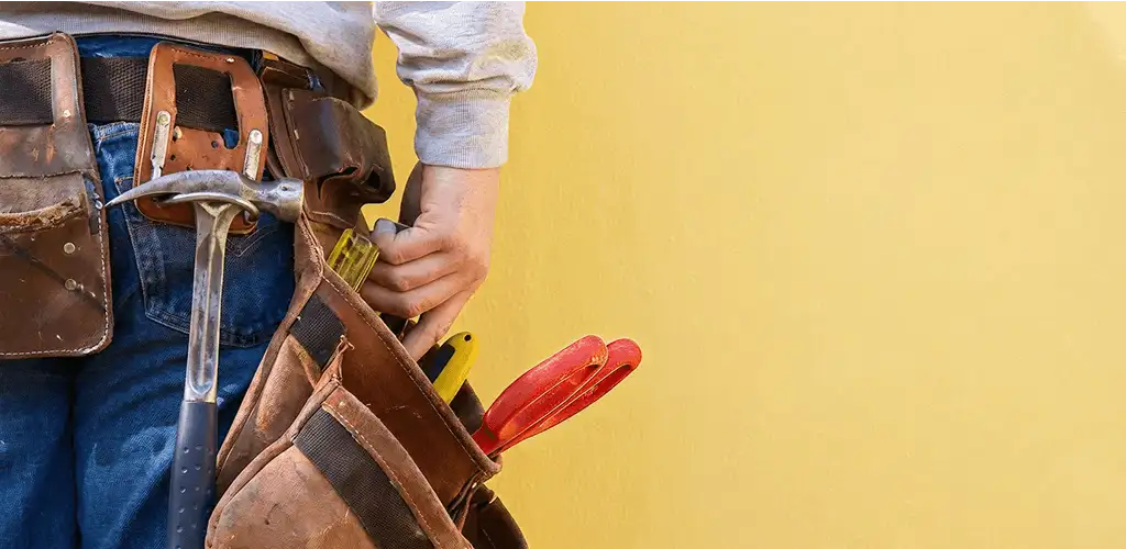Handyman with tool belt ready for home repairs and maintenance in Syracuse, NY