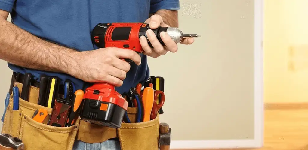 Handyman holding a power drill for home repairs and installations in Syracuse, NY