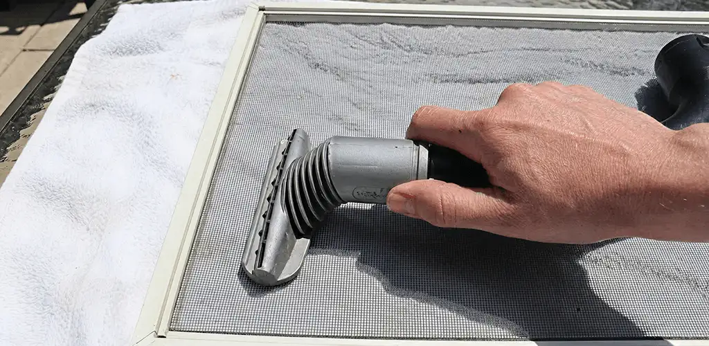 Window screen repair cleaning and fixing a damaged screen mesh in Syracuse, NY