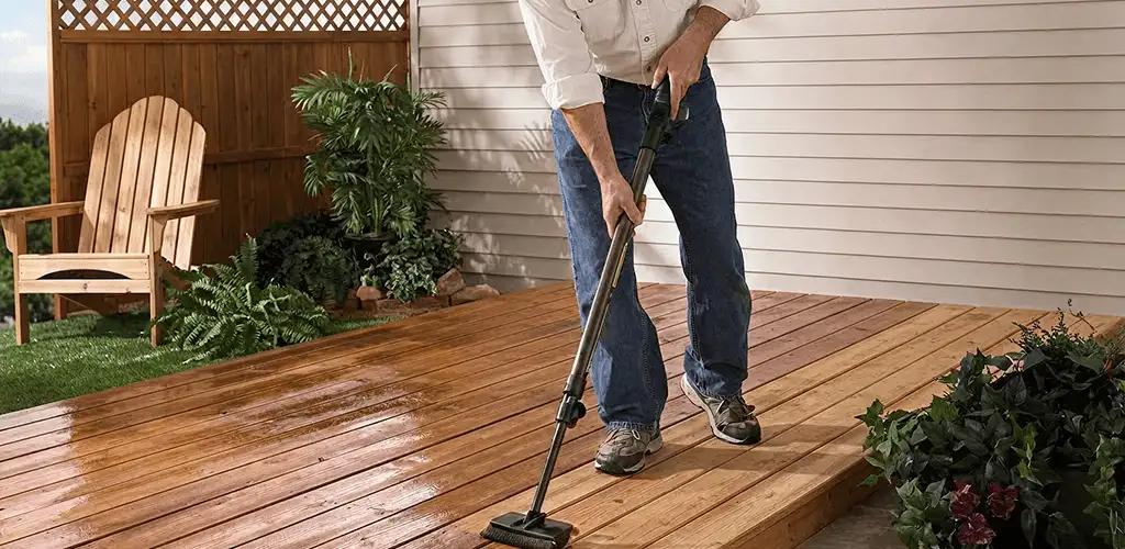 Deck staining service applying stain to a backyard wood deck in Syracuse, NY